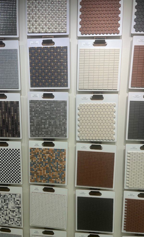 A wall with a variety of tiles on it