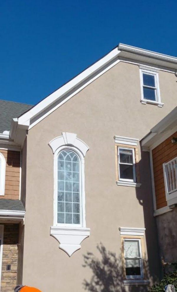A house with a lot of windows and a blue sky in the background