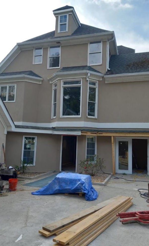 A large house with a lot of windows is being built