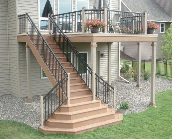 A house with a deck and stairs leading up to it