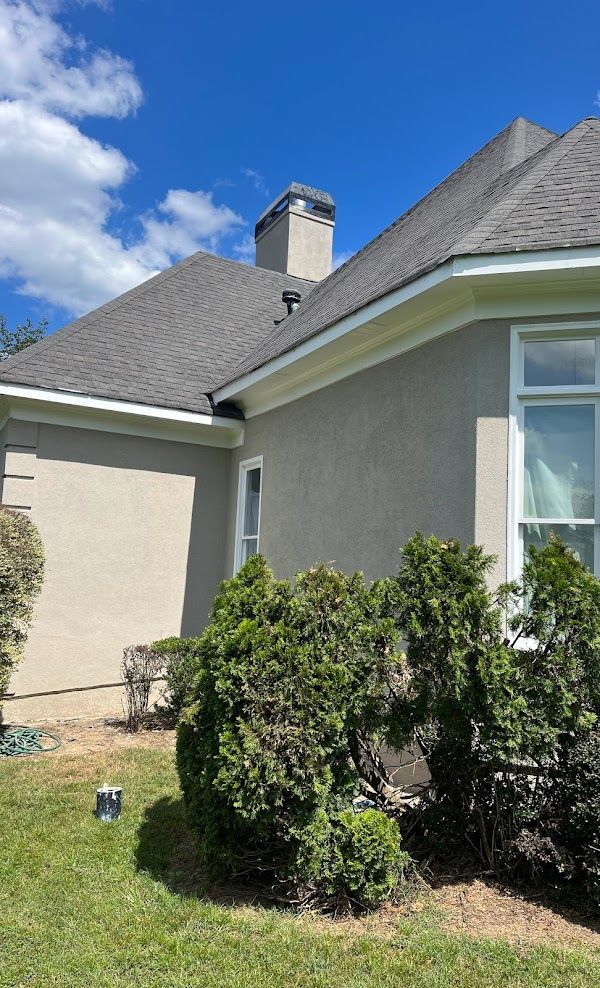 The side of a house with a chimney on the roof