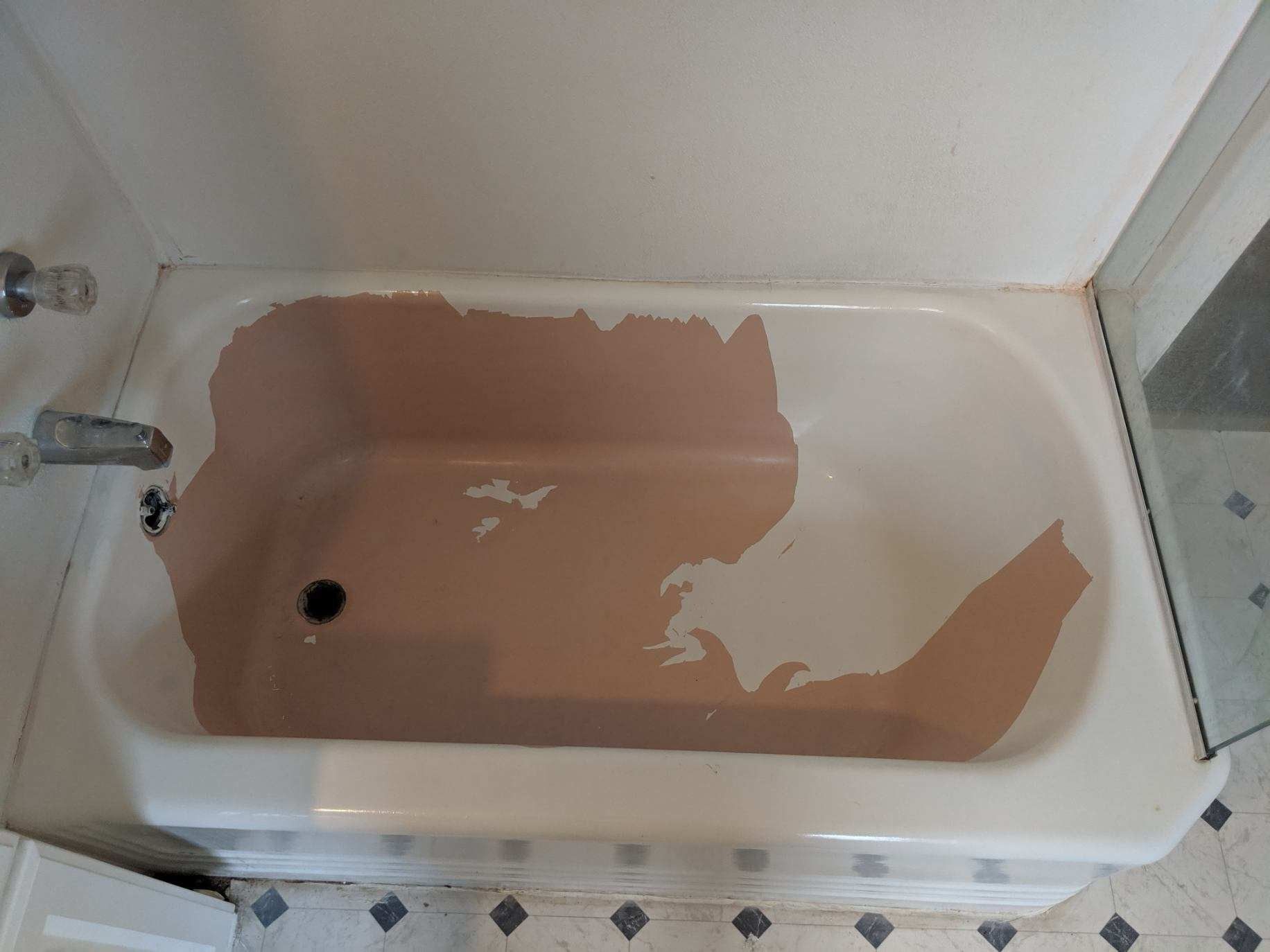 Bathtub with peeling brown paint; white exterior, chrome faucet, set in a bathroom with blue and white patterned floor.