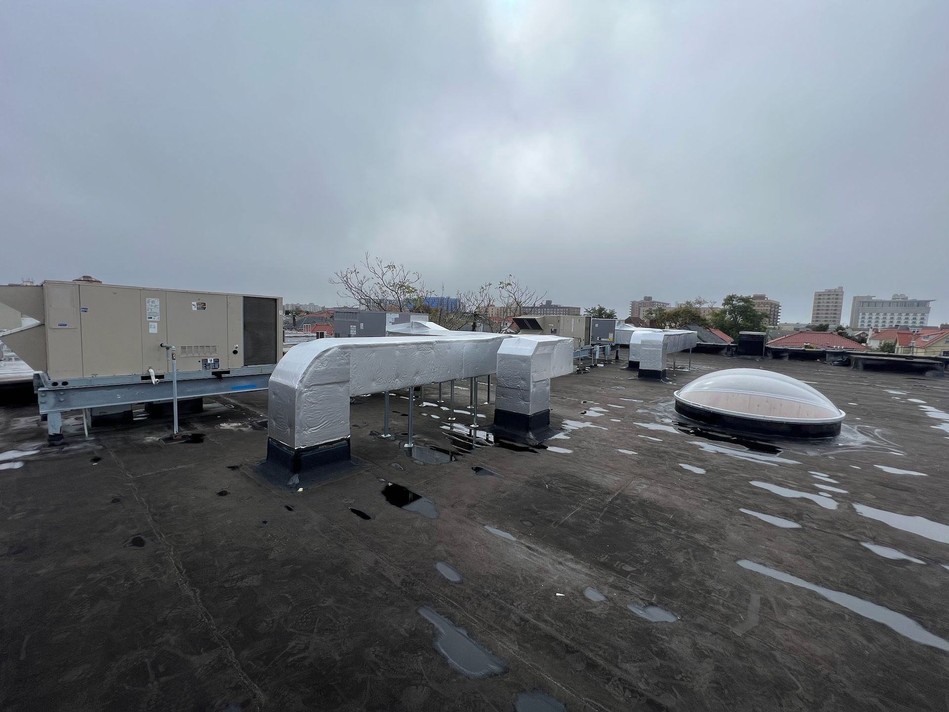 an aerial view of the roof of a building with a lot of pipes on it