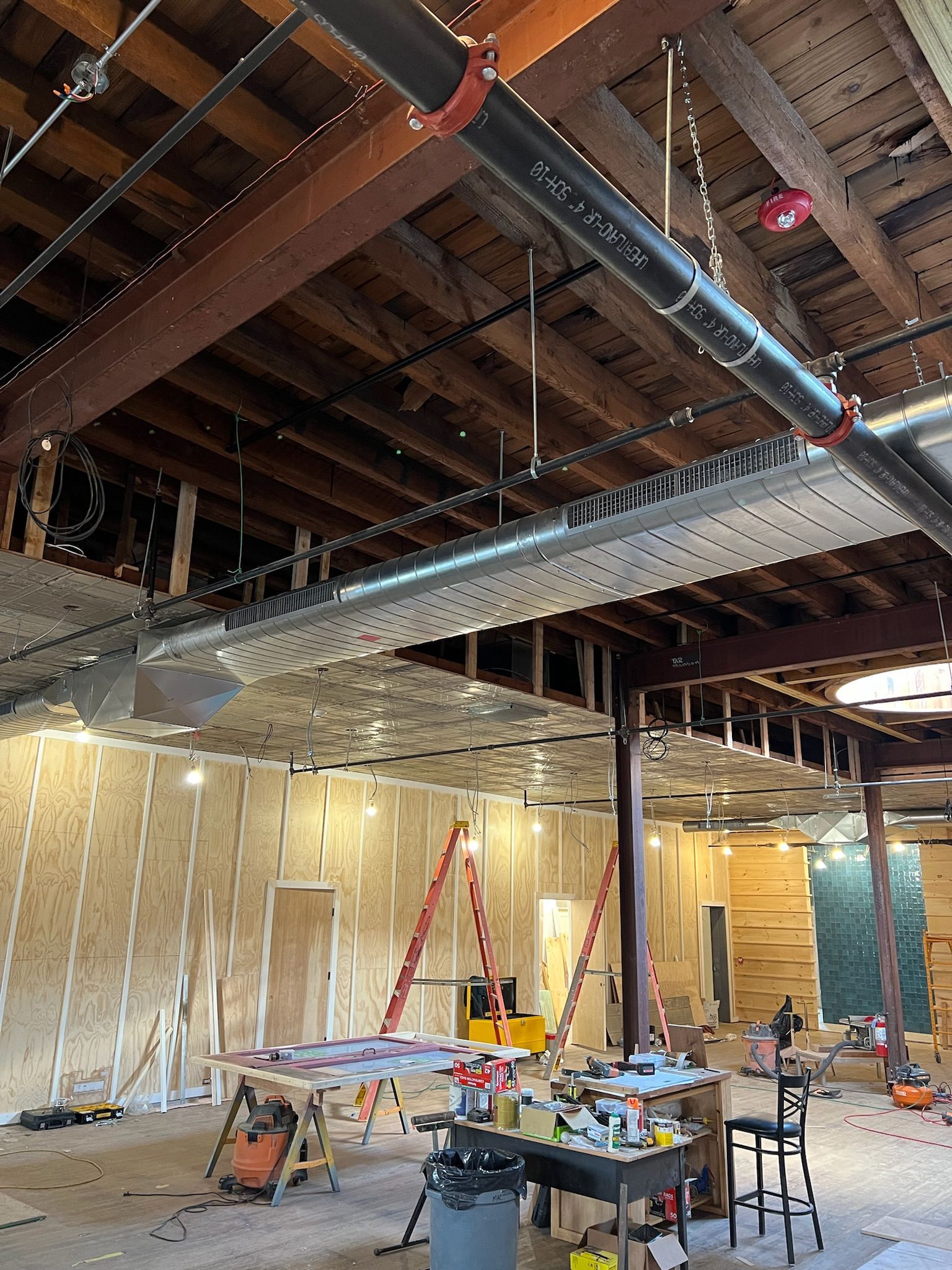 a large room with a lot of pipes hanging from the ceiling