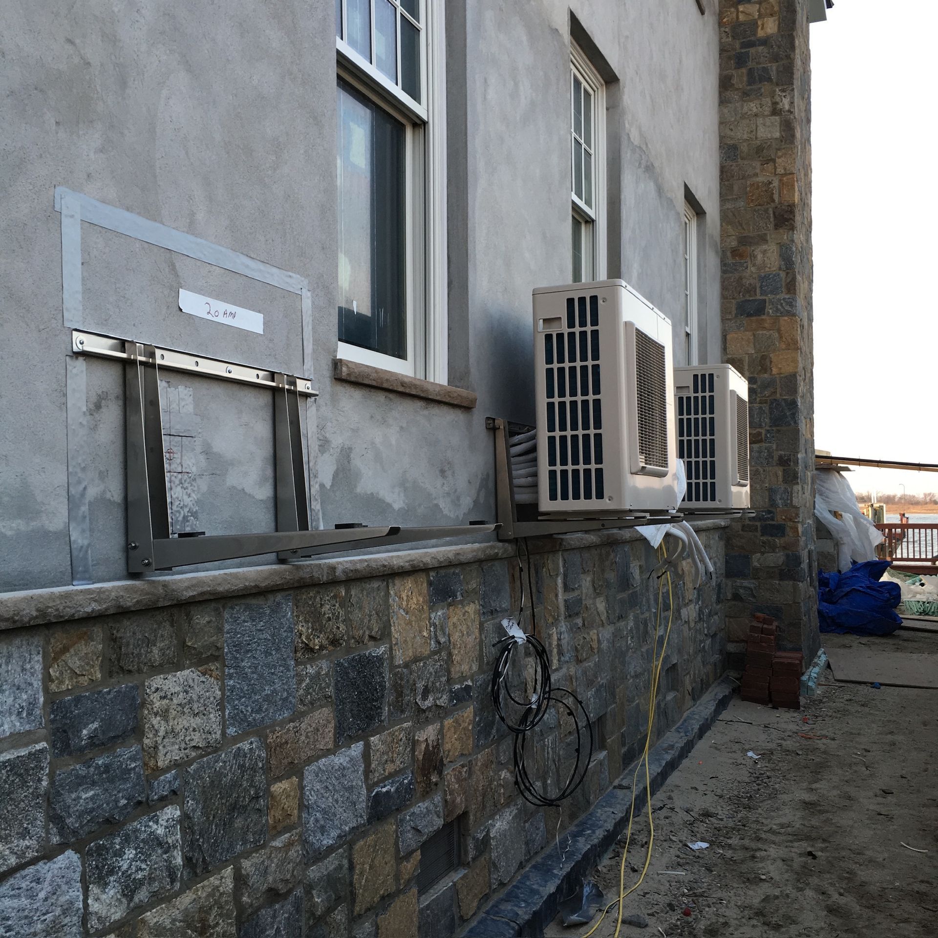 a building with a lot of windows and air conditioners on the side