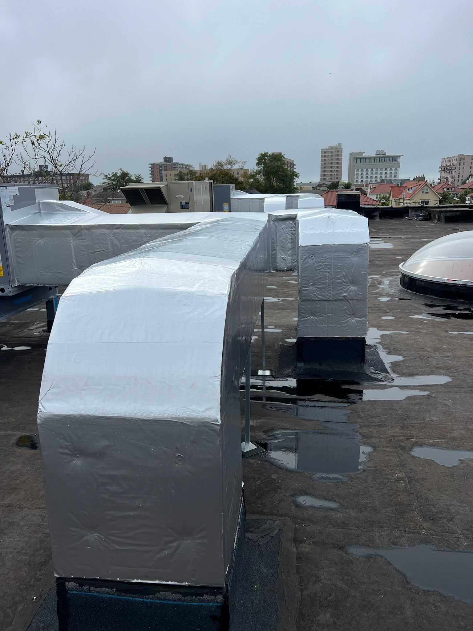 a row of ducts on the roof of a building