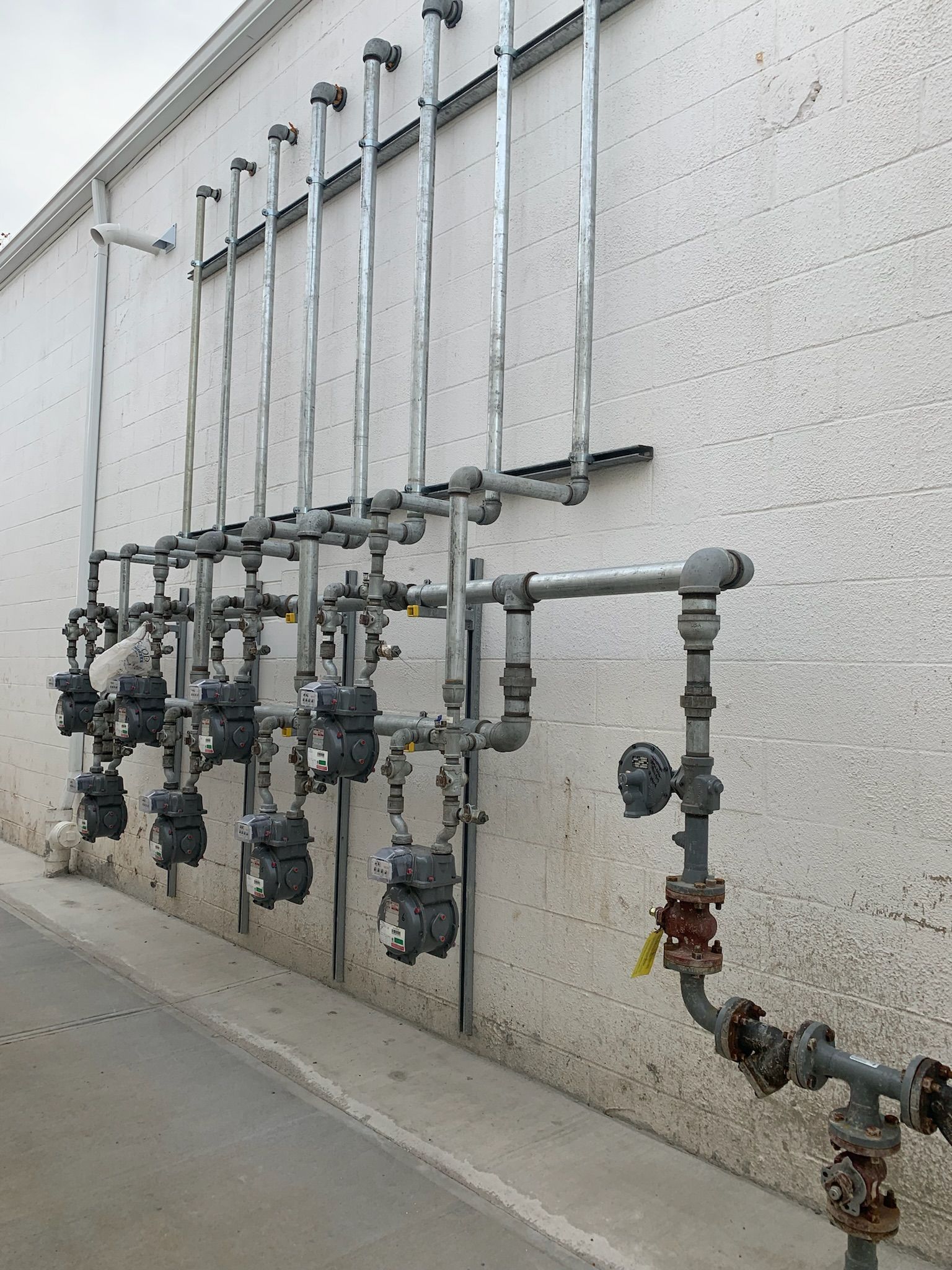 a wall with a bunch of pipes attached to it