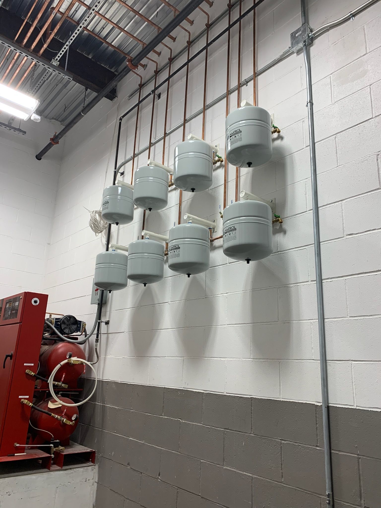 a room with a lot of pipes hanging on the wall