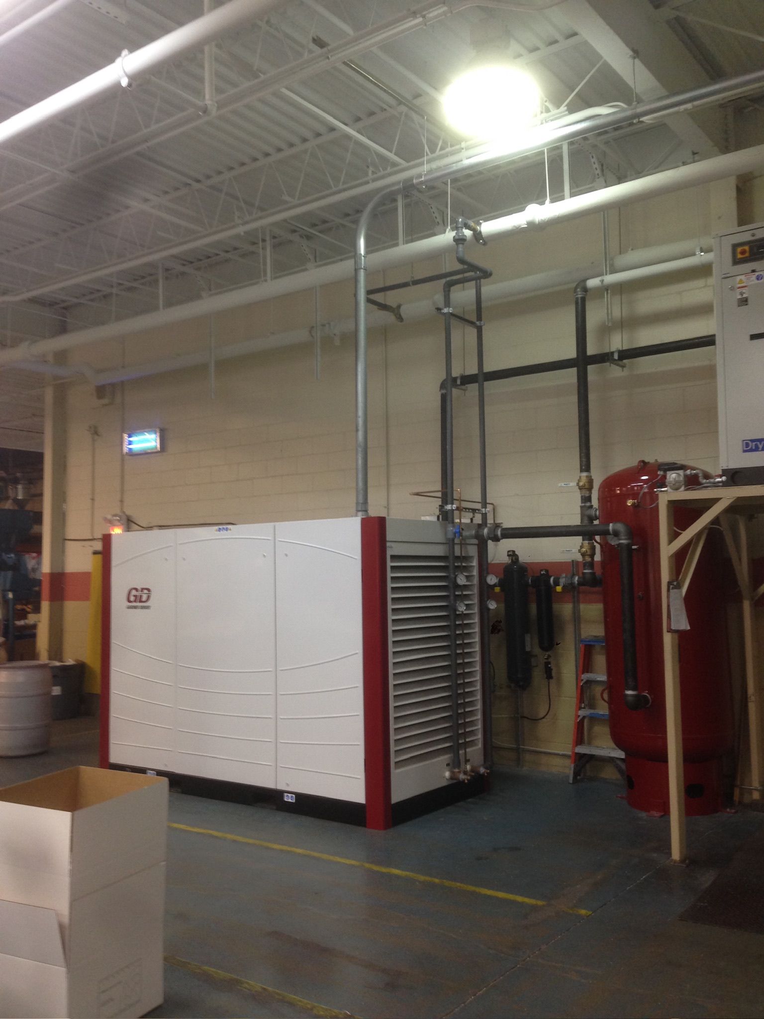 a warehouse with a large white and red machine