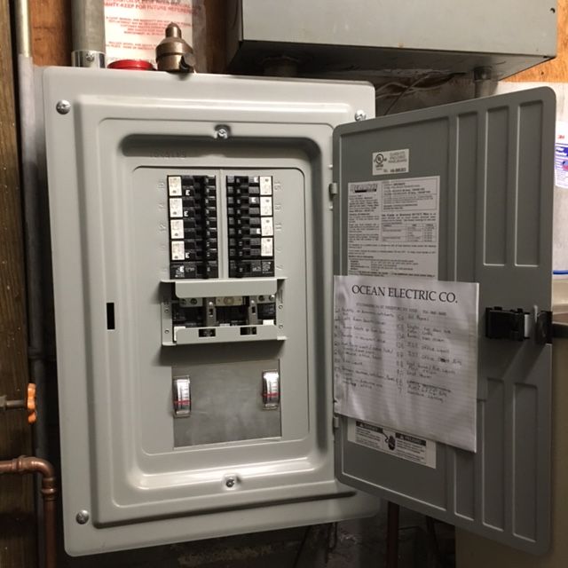 an electrical box with the door open and a note on it