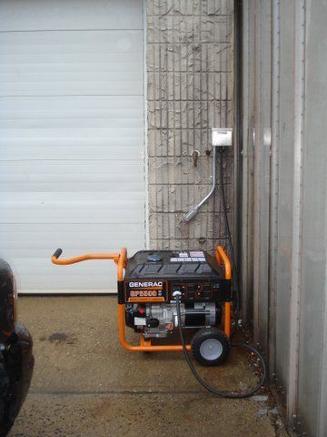 a generator is plugged into a wall next to a garage door