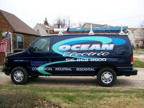 a blue ocean electric van is parked in front of a house