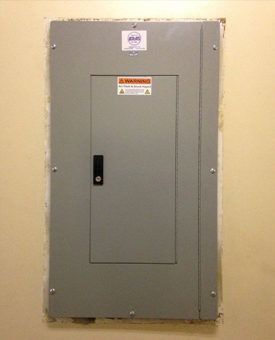 a gray electrical box with a warning label on it