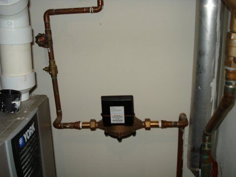 a york air conditioner is sitting next to a water meter