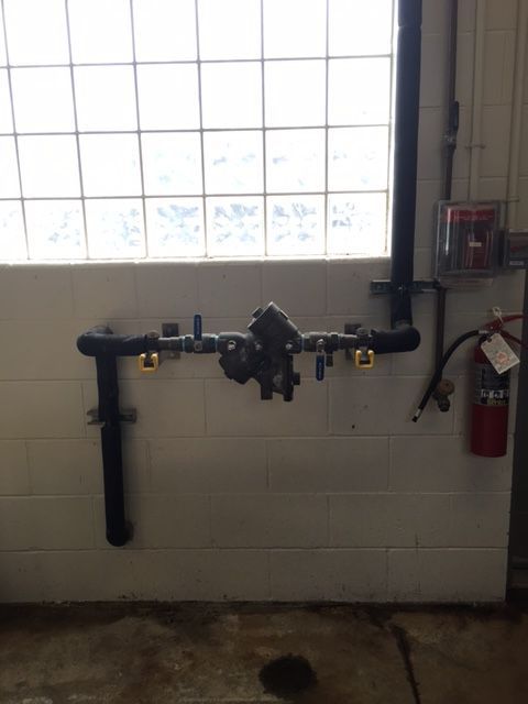 a fire extinguisher is hanging on a wall next to a window