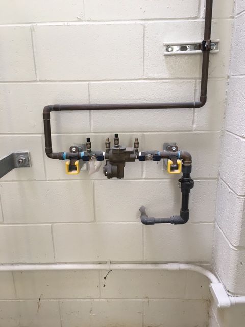 a close up of a pipe on a brick wall