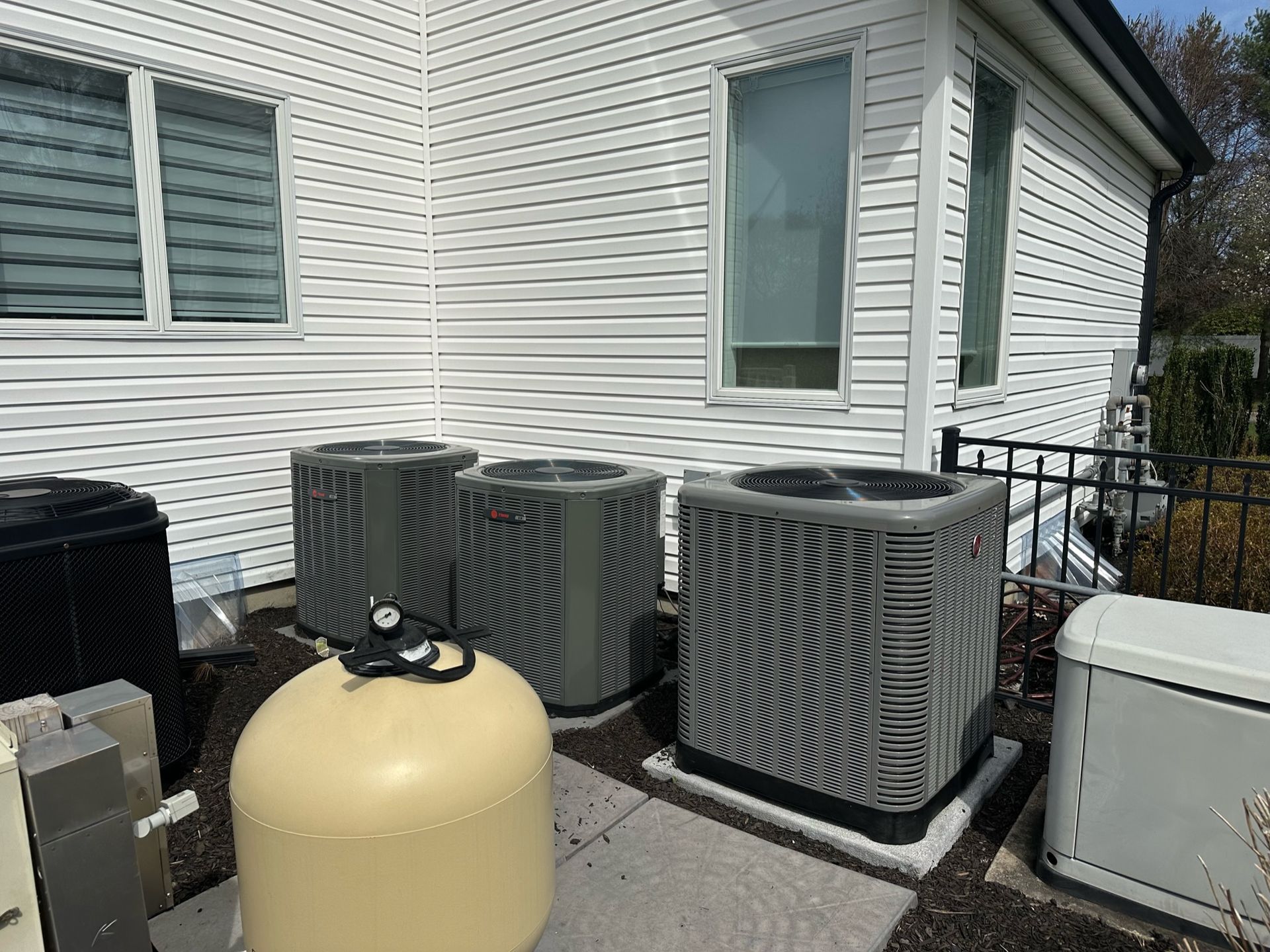 a house with a lot of air conditioners on the side of it .