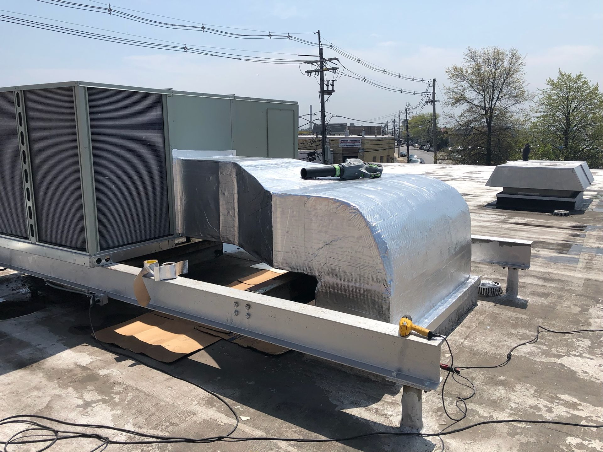 a large air conditioner is sitting on top of a roof .