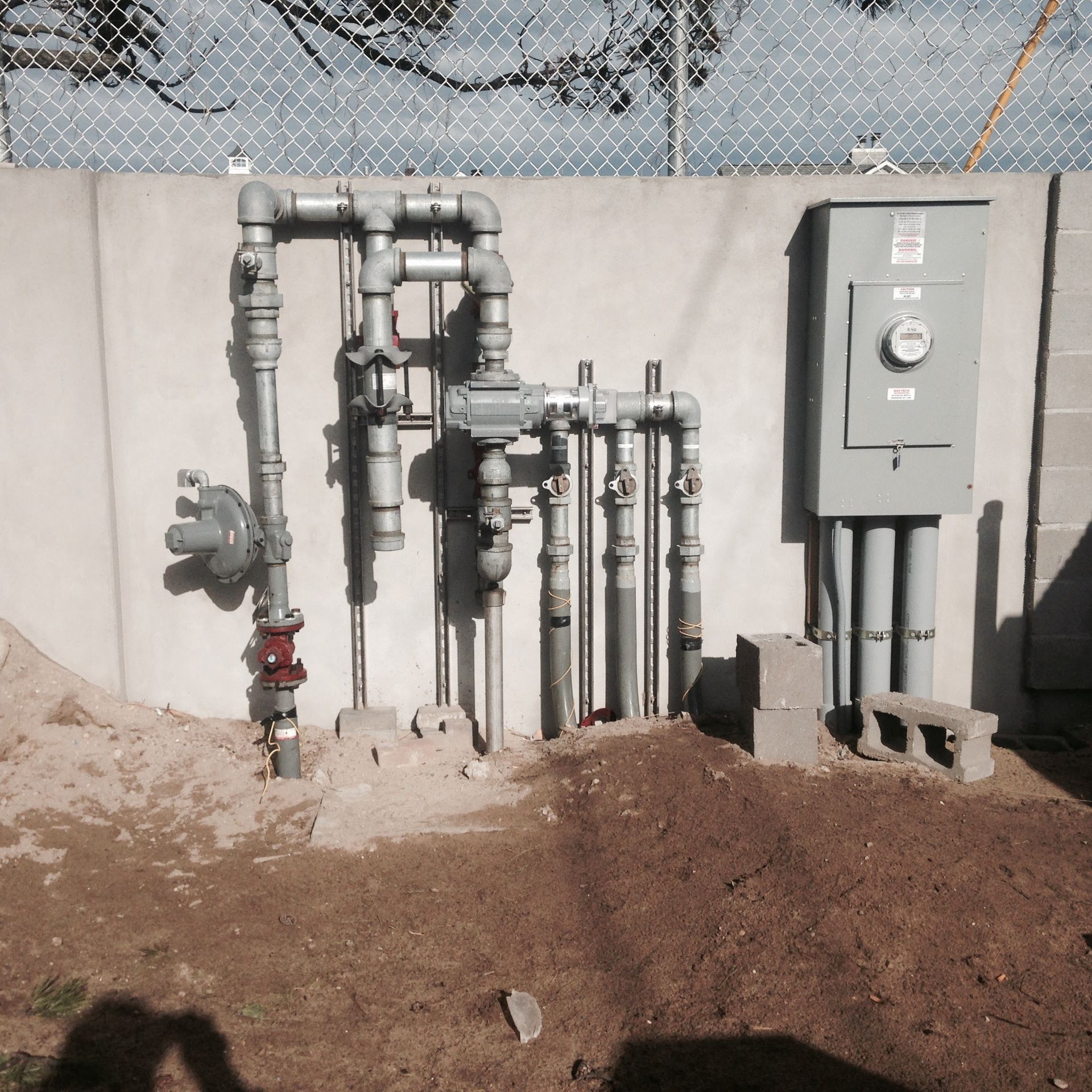 a concrete wall with a bunch of pipes attached to it