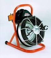 Orange hose reel cart with coiled black hose on a metal frame