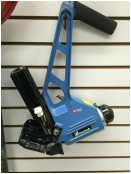 Blue handheld label printer hanging on a store display wall