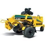 Yellow Vermeer SC352 compact loader with black wheels and front attachment on white background