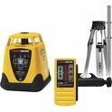 Yellow rotary laser level kit with tripod and receiver on white background