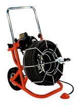 Portable red drain cleaning machine with coiled cable and metal handle