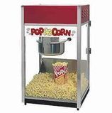 Red-and-white popcorn machine filled with popcorn in a clear glass cabinet.