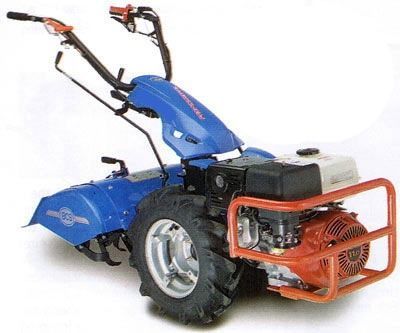 Blue walk-behind tiller with black handles and orange engine on a white background
