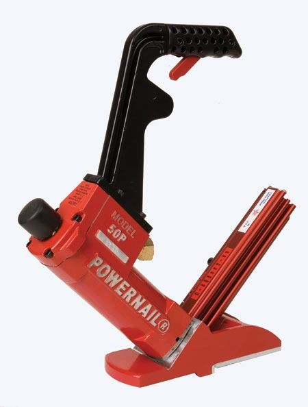 Red and black Powerball exercise device with handle and base on a white background