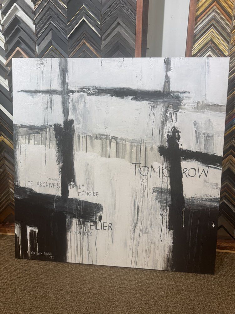 Abstract black and white painting with dripping paint effect. It reads 