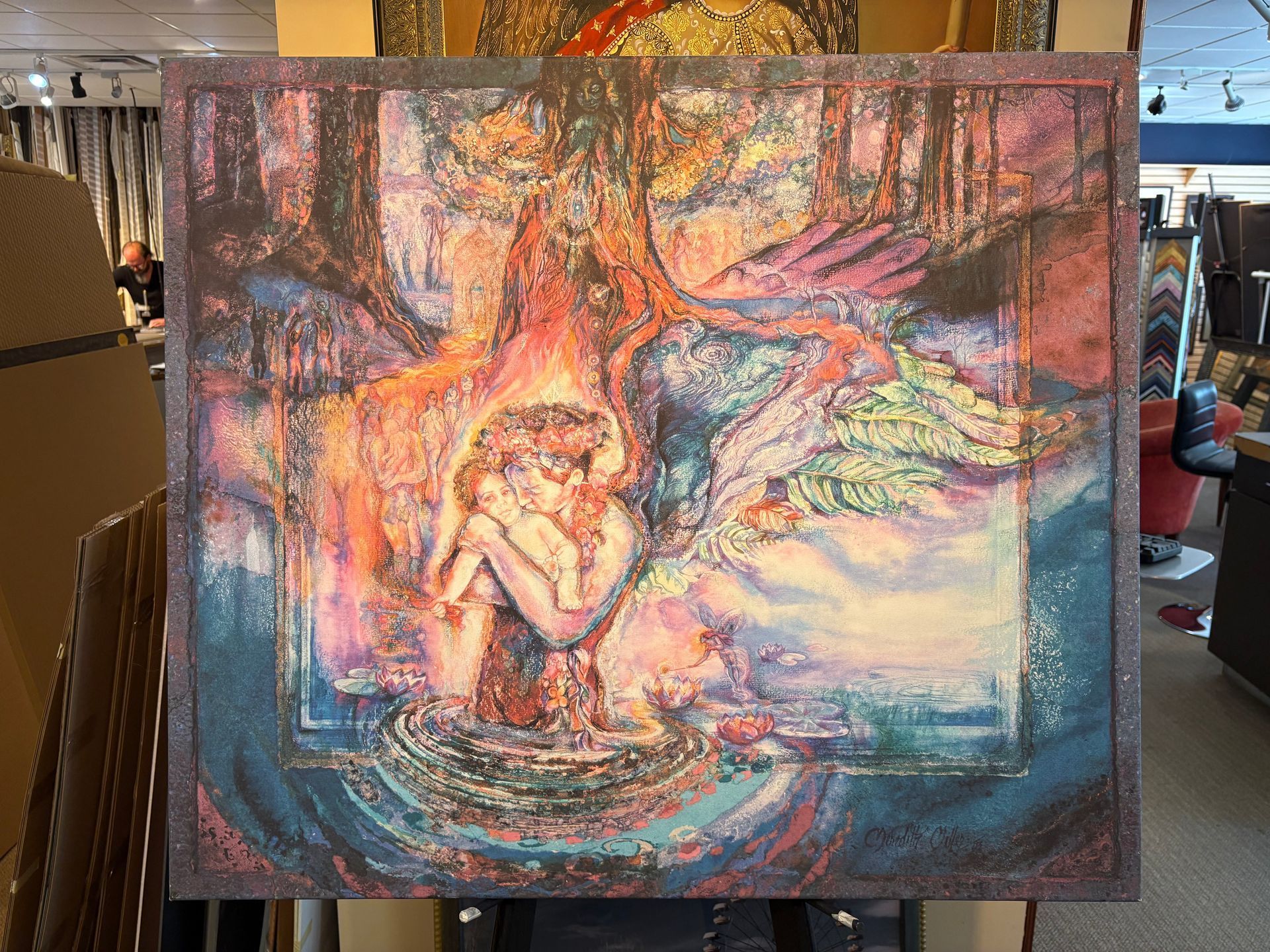 A colorful painting shows a person curled up in water beneath a tree. The scene is surrounded by vibrant, ethereal colors.