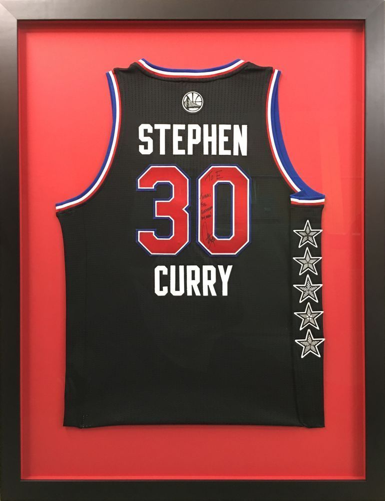 A stephen curry jersey is framed in a red frame