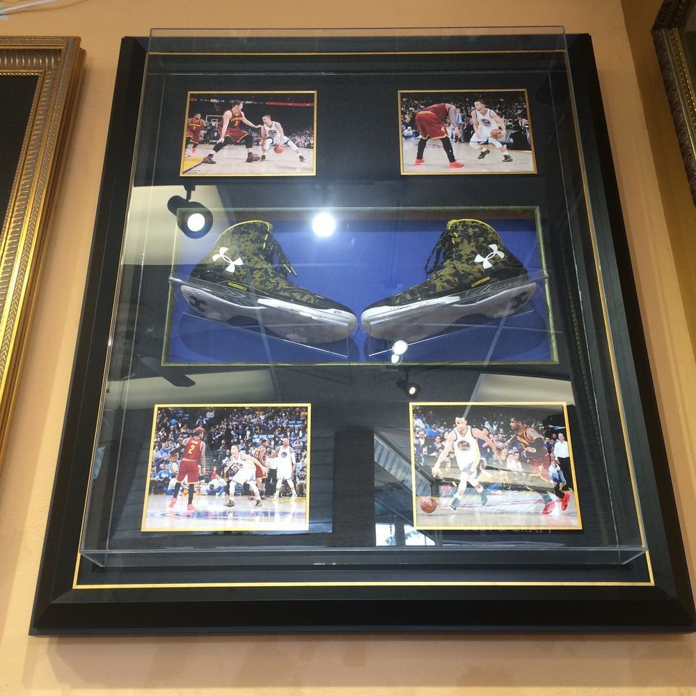 A framed picture of a pair of under armour shoes