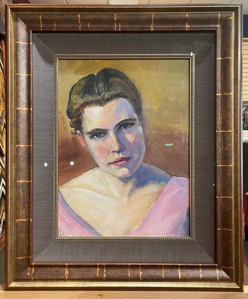 Oil painting of a woman in a pink dress against a yellow background. She has a gentle expression and is framed in gold.