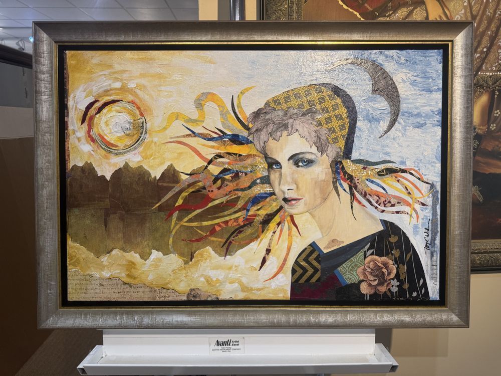 painting of a woman with colorful hair against a landscape, framed in silver