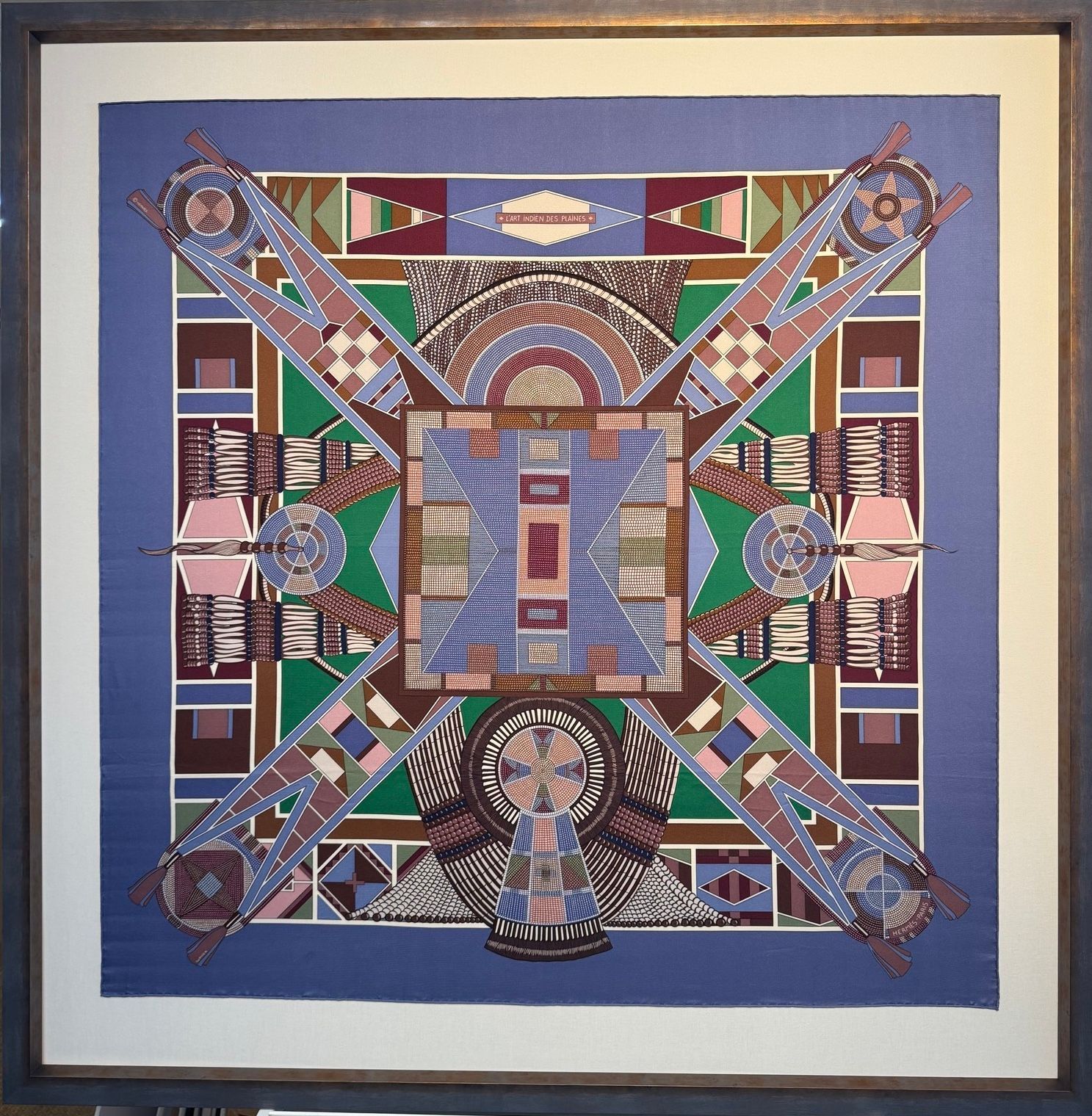 Colorful geometric mosaic artwork with a blue center, symmetric cross-like design, and framed border