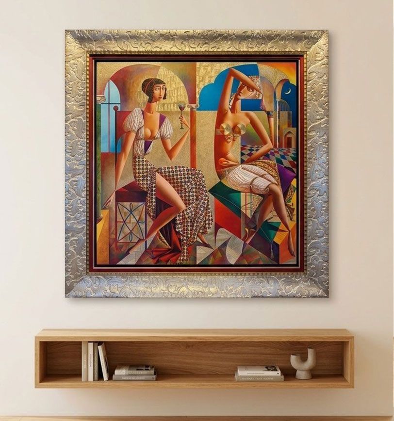 An original framed painting hanging on a wall.