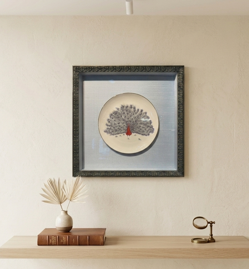 A framed, 3D artwork mounted on a wall.
