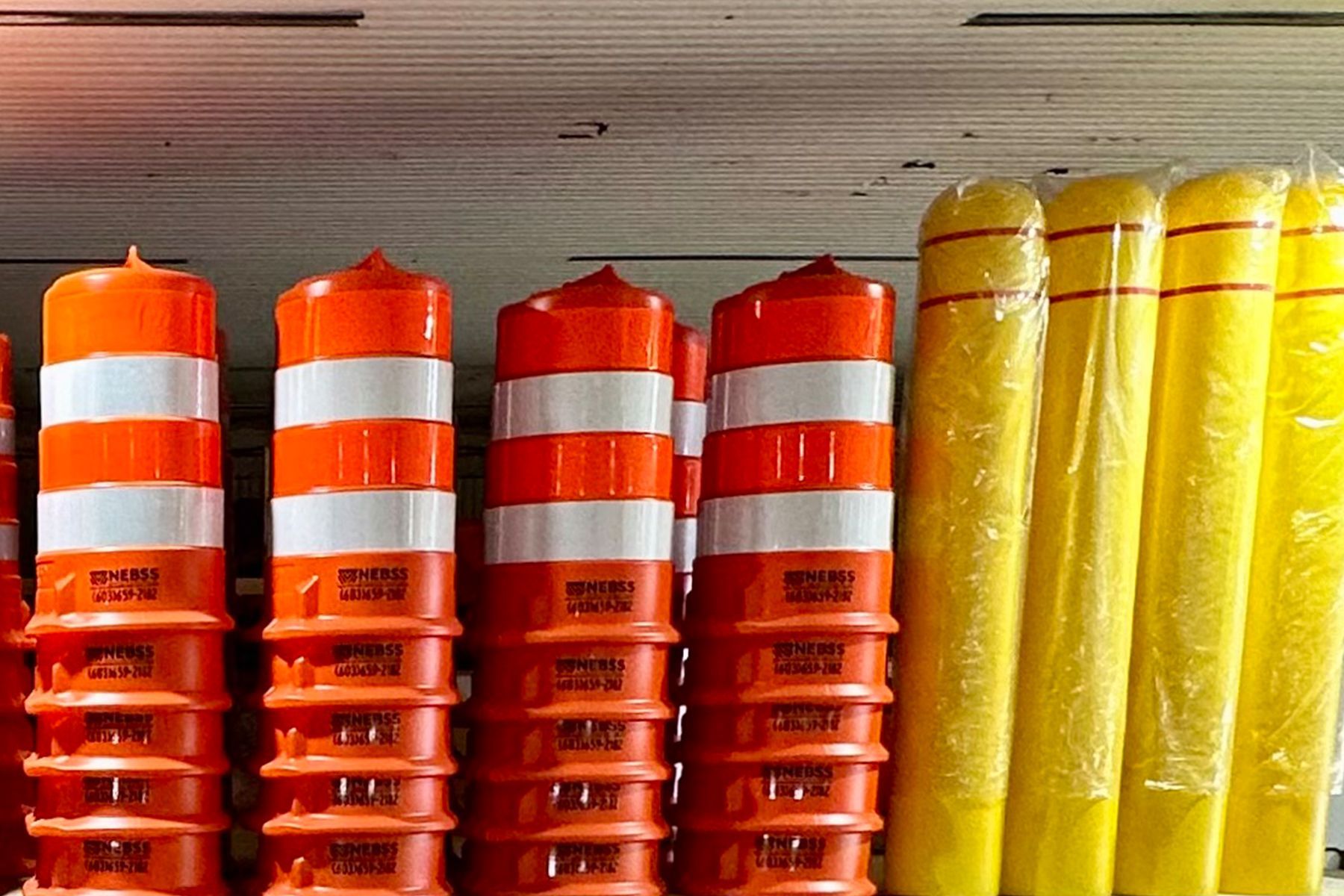 A bunch of orange and yellow traffic cones stacked on top of each other
