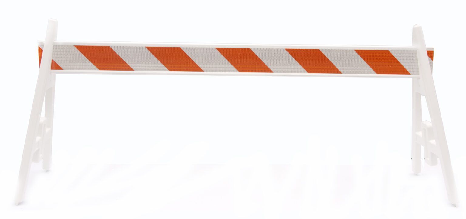 A white and orange striped plastic barrier