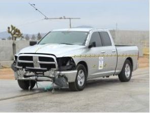 A silver truck with a broken bumper