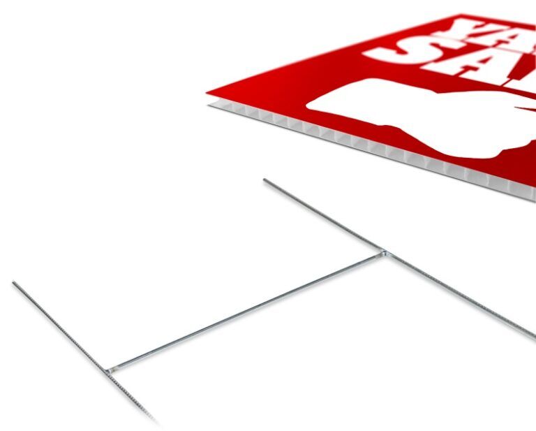 A red and white yard sign with the word sale on it