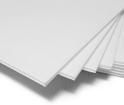 A bunch of white sheets of paper are stacked on top of each other on a white surface.
