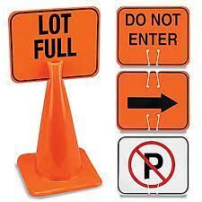 A lot full and do not enter signs are attached to an orange traffic cone.
