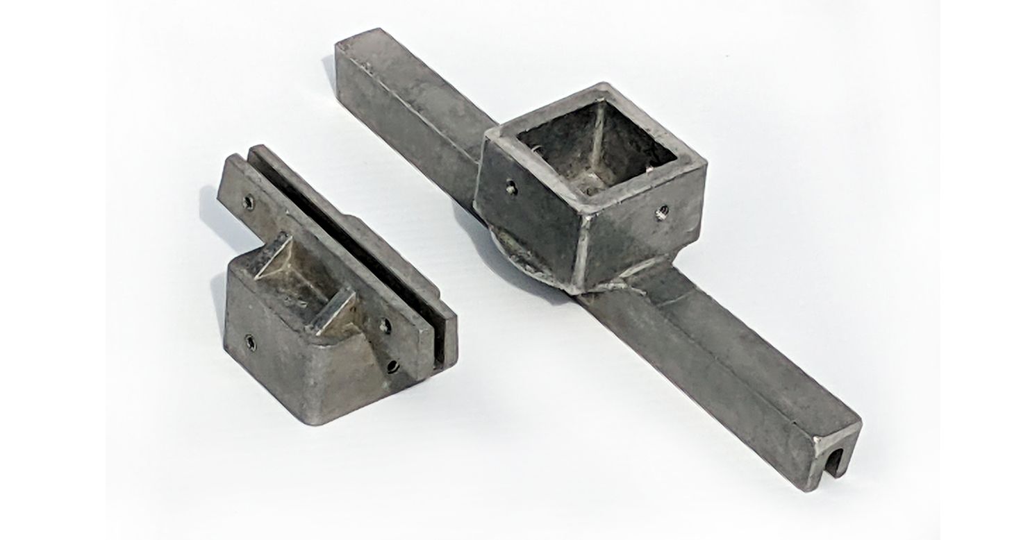 A close-up of a metal object on a white surface.