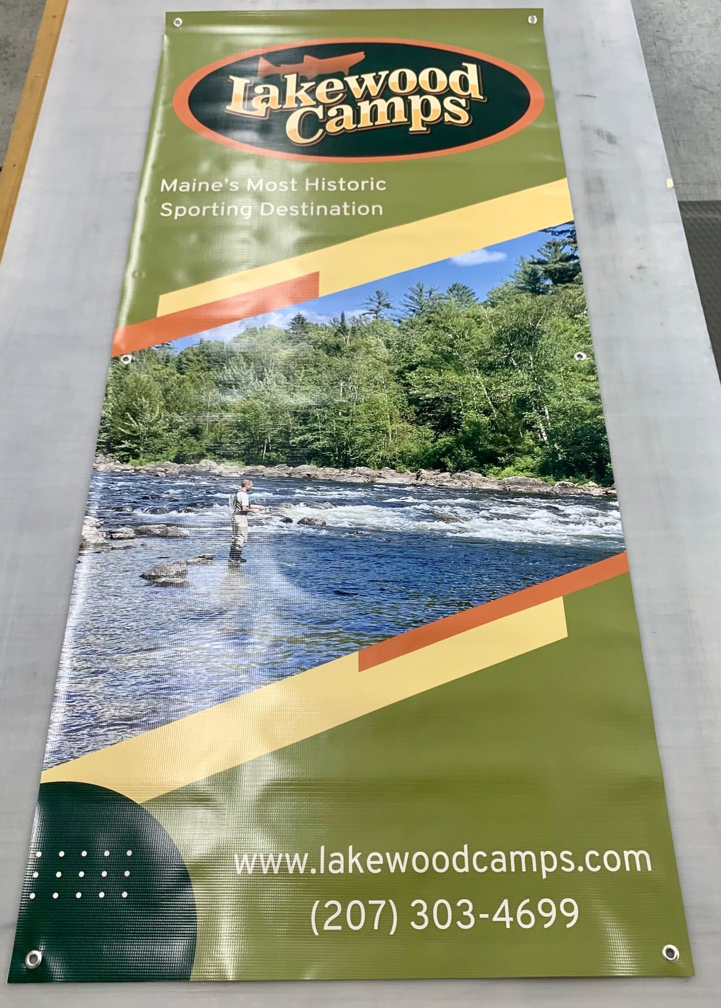 A banner for lakewood camps is sitting on a table.