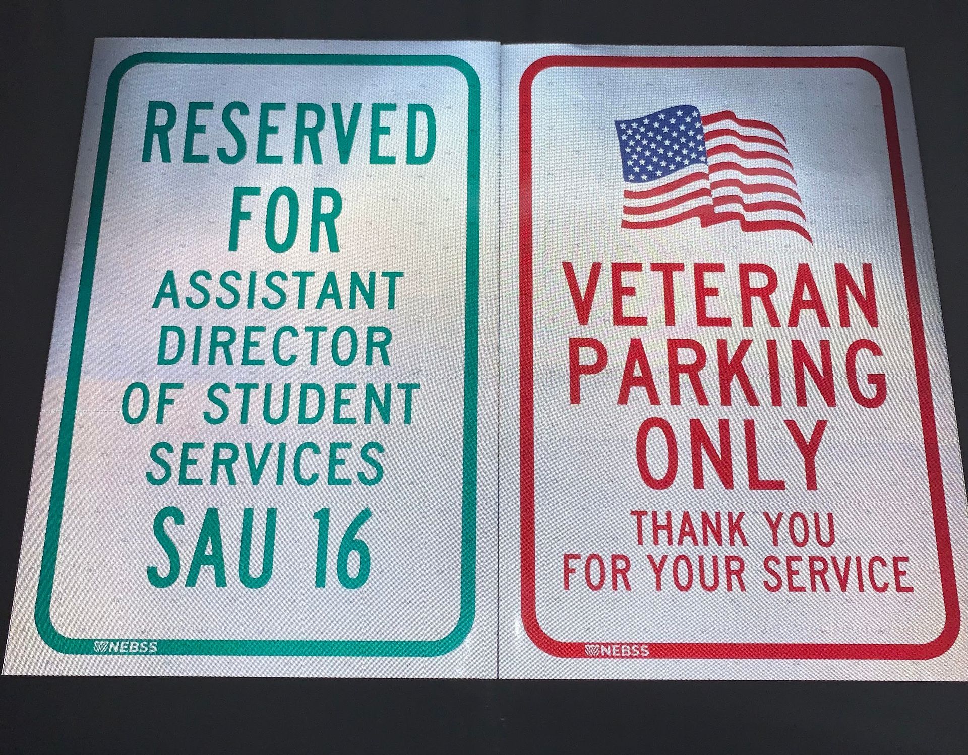 Two signs that say reserved for assistant director of student services and veteran parking only