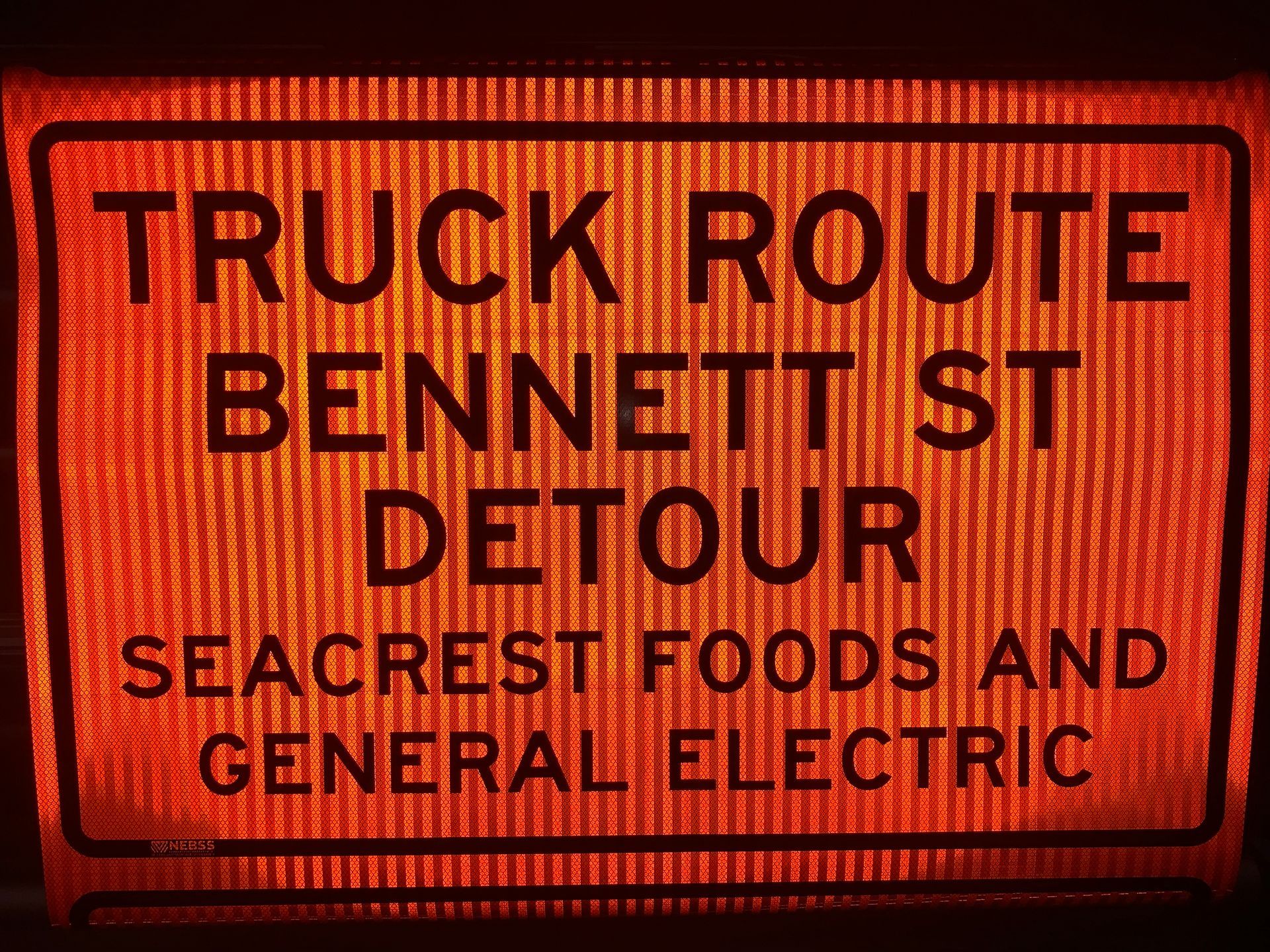 A sign that says truck route bennett st detour seacrest foods and general electric